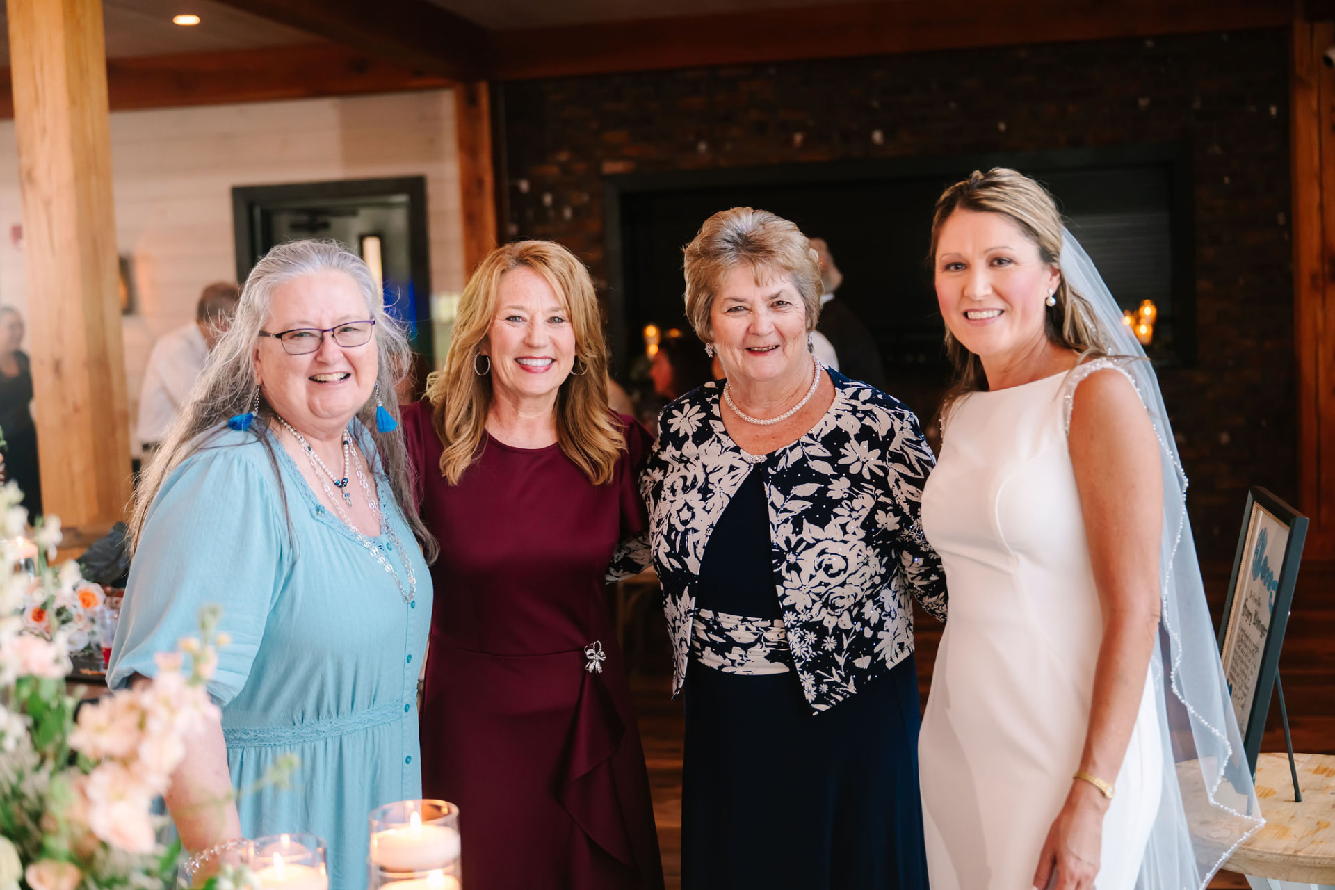 Sonnie smiling with three family members at the reception