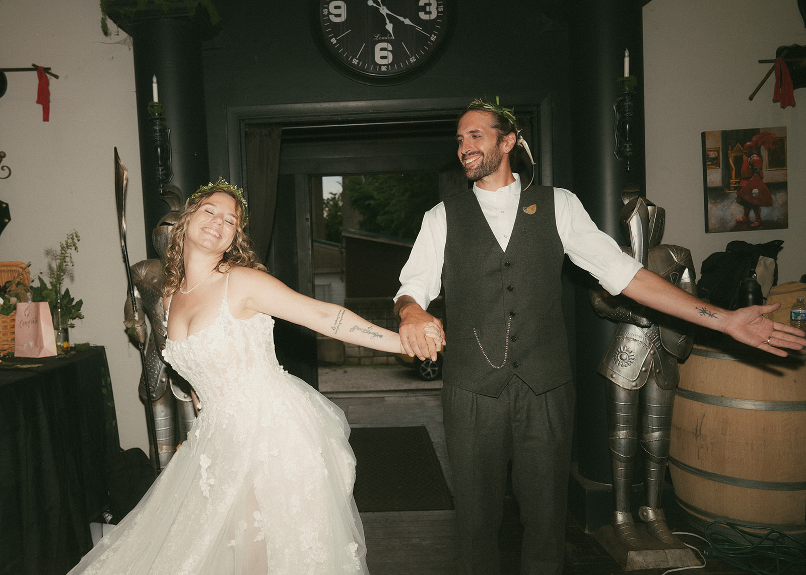 Dani and Matt making their entrance beside suits of armor
