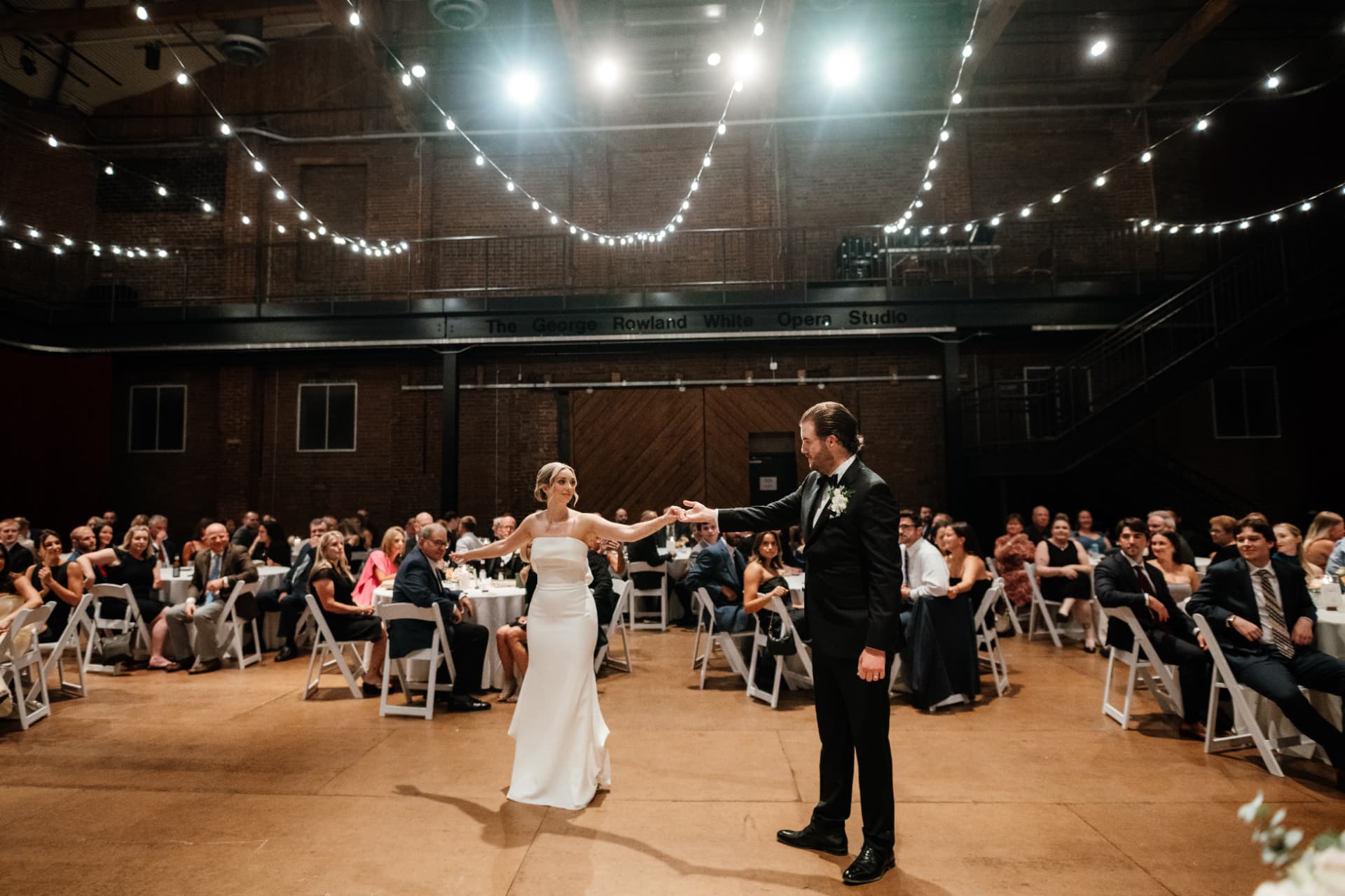 Sydney and Duncan's first dance under string lights