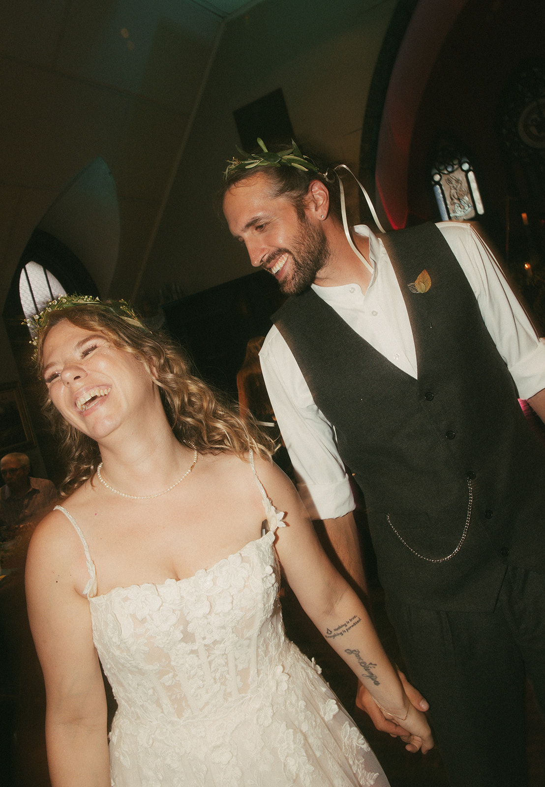 Dani and Matt laughing together inside the reception space