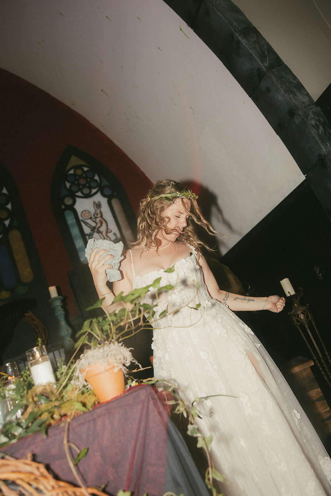 Dani celebrating near stained glass windows and greenery